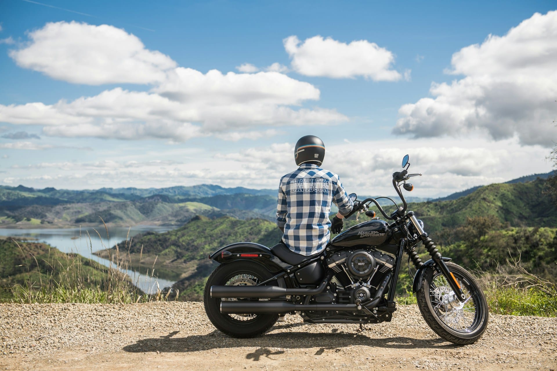 man sitting on harley davidson motorcycle